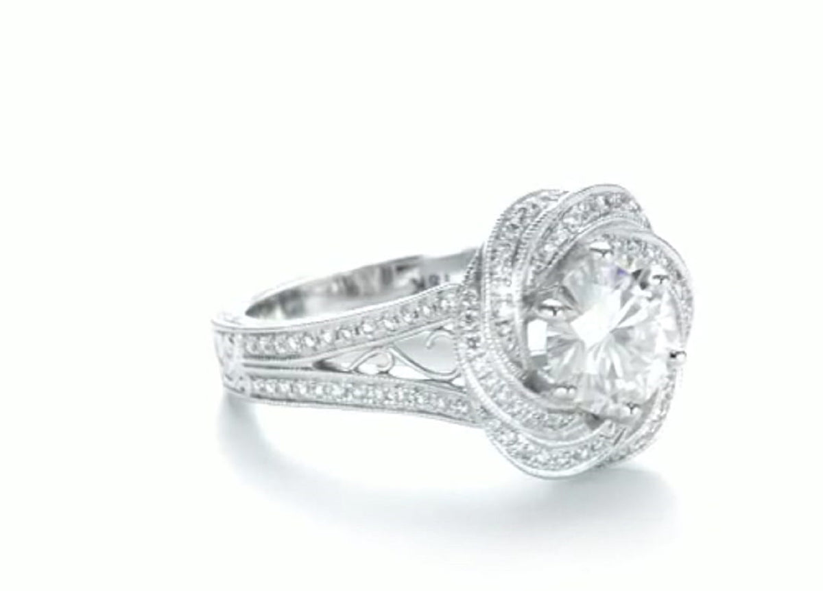 Three-quarter side profile view of a vintage 2 carat round lab diamond swirl halo ring.