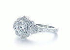 Angled view of a 3 CT round lab grown diamond engagement ring with a scalloped floral halo and leaf shoulder details.