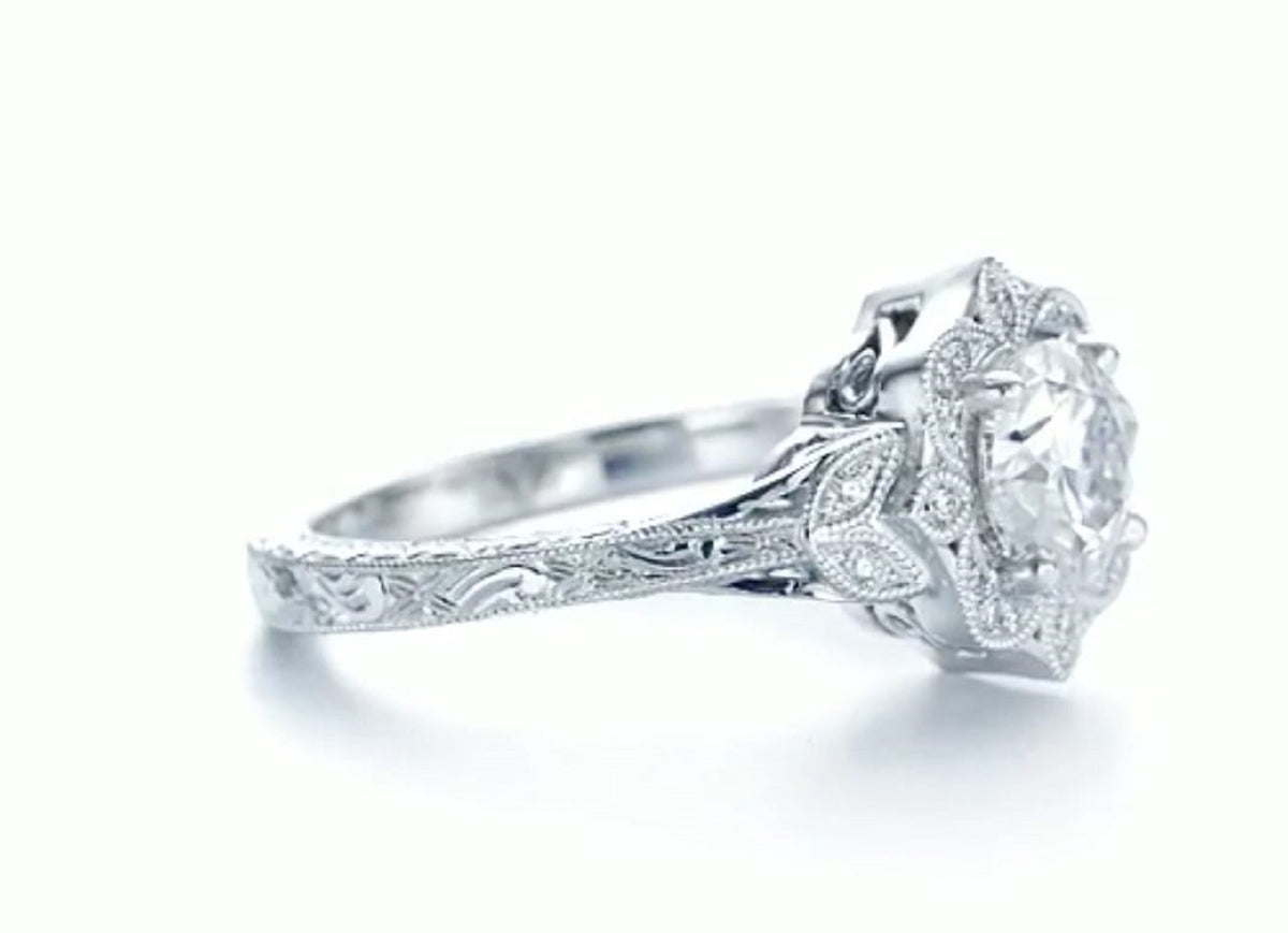 Perspective side shot showing hand-engraved vintage scrollwork along the shank of a 3 carat lab diamond ring.