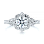 Clean studio top-down view of a 3 CT round brilliant lab diamond in a floral halo setting with leaf shoulders.