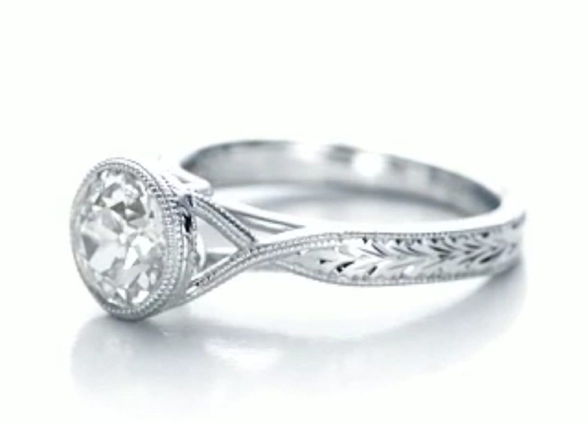 Side perspective showing the hand-engraved wheat motif along the white gold shank.