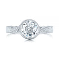 Top-down view of a 3 carat round lab diamond center stone held in a milgrain bezel setting.