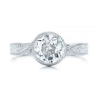 Top-down view of a 3 carat round lab diamond center stone held in a milgrain bezel setting.