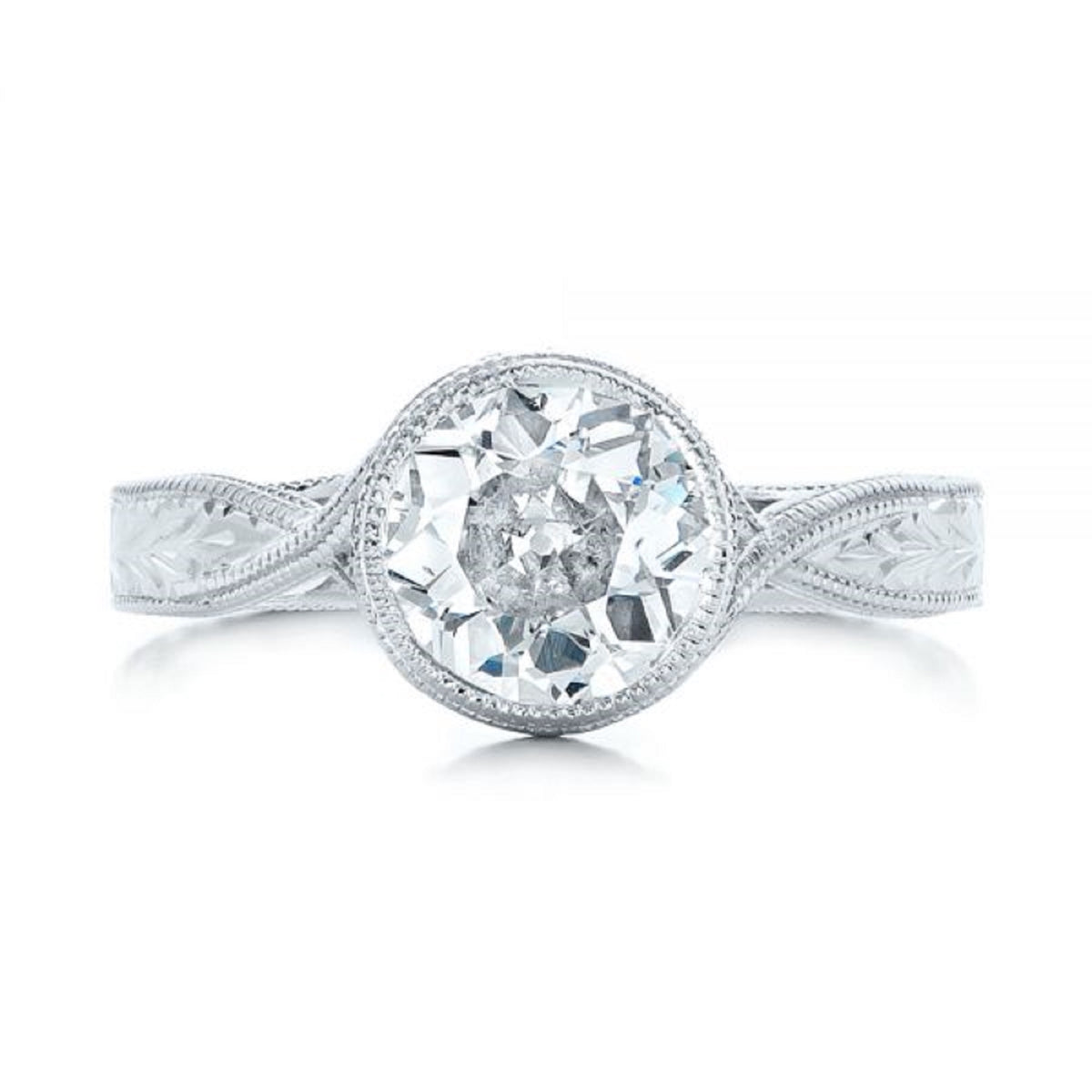 Top-down view of a 3 carat round lab diamond center stone held in a milgrain bezel setting.