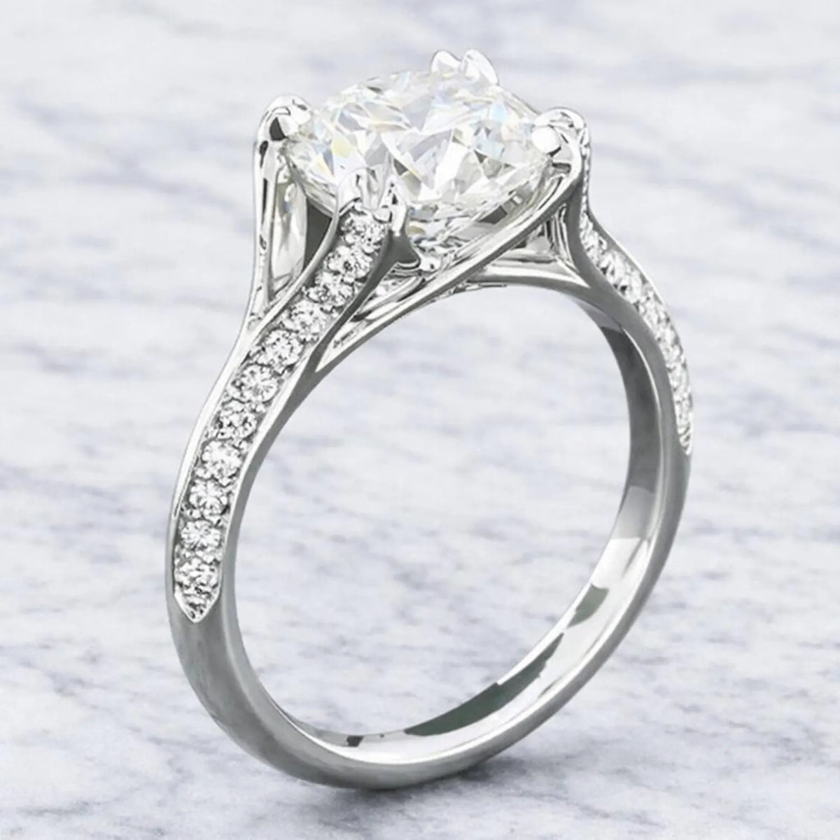 Three-quarter angle showing a 3 CT round brilliant lab grown diamond ring featuring a cathedral setting and pavé diamond band.