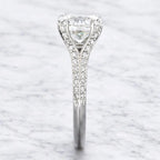 Edge-on view highlighting the micro-pavé diamond split bridge and polished band profile of a 3 carat round lab diamond ring.