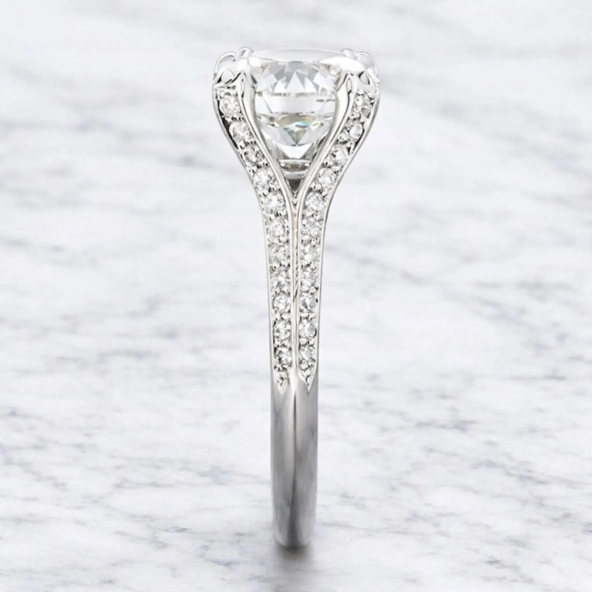 Edge-on view highlighting the micro-pavé diamond split bridge and polished band profile of a 3 carat round lab diamond ring.