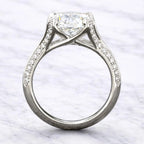 Direct side profile view illustrating the architectural cathedral arch and under-gallery basket of a 3 carat round lab grown diamond engagement ring.