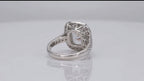 Bottom view showing intricate openwork filigree undergallery and polished inner band of a 3 carat cushion cut lab grown diamond halo ring.