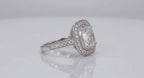 Side three-quarter angle view of a 3 ct cushion cut lab grown diamond ring with milgrain-bordered halo and accent-set band.