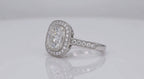 Perspective view highlighting the sparkling cushion cut lab diamond center, beaded milgrain halo, and paved diamond shoulders.