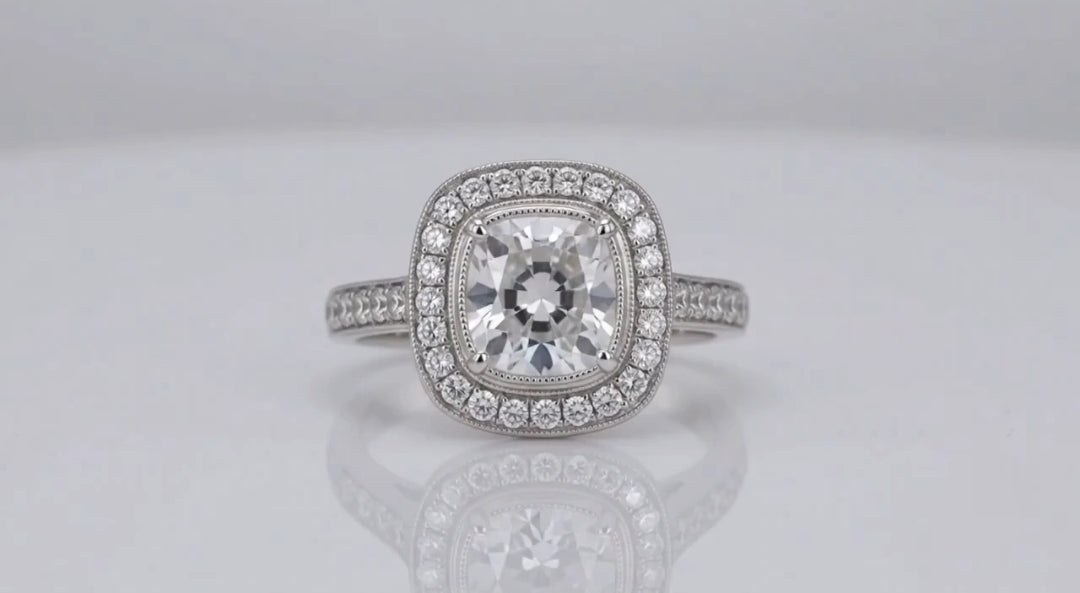 Direct face-up top view of a 3 carat cushion cut lab grown diamond surrounded by a vintage milgrain halo setting.