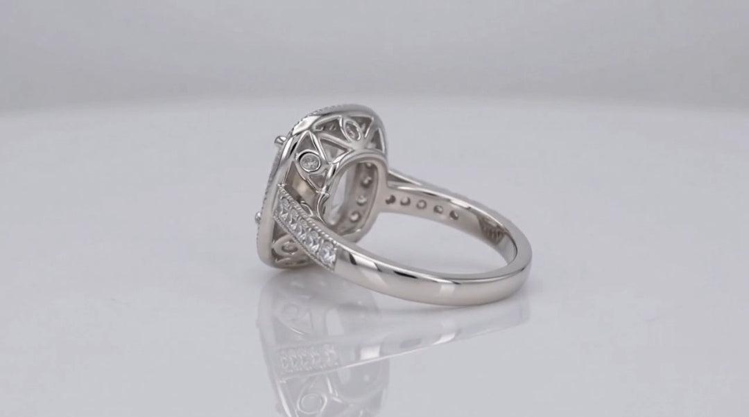 Rear side profile view revealing the detailed lattice gallery work and diamond-accented shoulders of a cushion cut engagement ring.