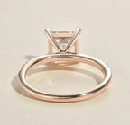 Side profile view showing the slender open basket wire setting and smooth rose gold shank of a 2ct princess cut ring.