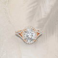 3 carat oval cut lab grown diamond halo ring with a pave split shank in rose gold.