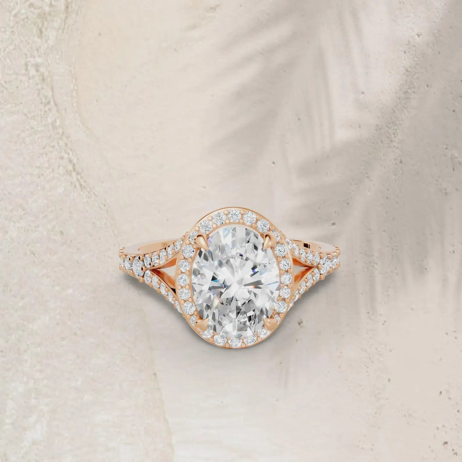 3 carat oval cut lab grown diamond halo ring with a pave split shank in rose gold.
