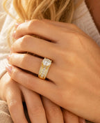 Model wearing a 3 carat round cut lab grown diamond wide band engagement ring in 14K yellow gold.