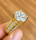 Close-up view of the channel-set round accent diamonds running along the wide yellow gold band.