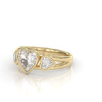 Perspective view displaying the split band profile and polished bezel frames of a 2 CT heart-shaped lab-grown diamond ring in 14K yellow gold.