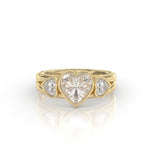 Frontal perspective of a 2-carat heart-shaped lab diamond engagement ring featuring bezel-set side hearts in 14K yellow gold.