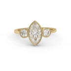 Underside open gallery backing view of a 3 carat marquise cut lab-grown diamond three-stone bezel ring in 14K yellow gold.