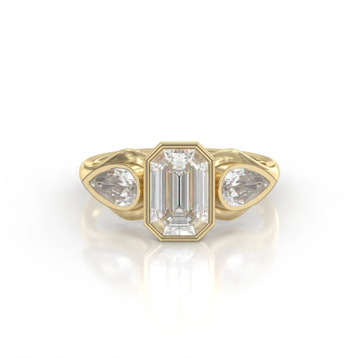 Front view of a 3 carat emerald cut lab grown diamond ring with bezel-set pear side stones in 14k yellow gold.