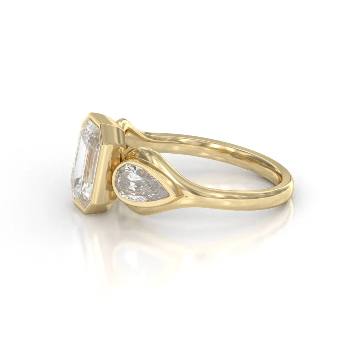 Profile detail view of the smooth bezel settings and pear-shaped side diamond accents.