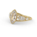 Top-angled perspective of a 3 carat marquise cut lab grown diamond engagement ring in yellow gold.