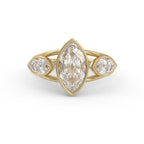 Front view of a 3 carat marquise cut lab grown diamond ring with bezel-set marquise side stones in yellow gold.
