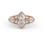 Front view of a 3 carat marquise cut lab grown diamond bezel engagement ring with side accents in 14k rose gold.
