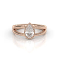 Rose gold 2 carat pear cut lab grown diamond ring with modern bezel setting and dual band split shank.