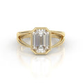 Front view of 3 CT emerald cut lab grown diamond engagement ring in yellow gold bezel setting with split shank band.