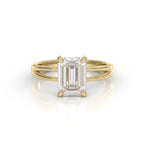 Front view of a 3 CT emerald cut lab grown diamond engagement ring in yellow gold with 4 prongs.