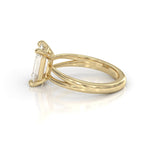 Side profile view showing the basket and split shank setting of a 3 carat emerald cut lab grown diamond ring.