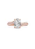 Top-down view of a 2 carat oval cut lab grown diamond ring with sweeping double-row pave shoulders in rose gold.
