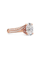 Angled front perspective showcasing the brilliant 2ct oval cut lab diamond and pave swirl band.