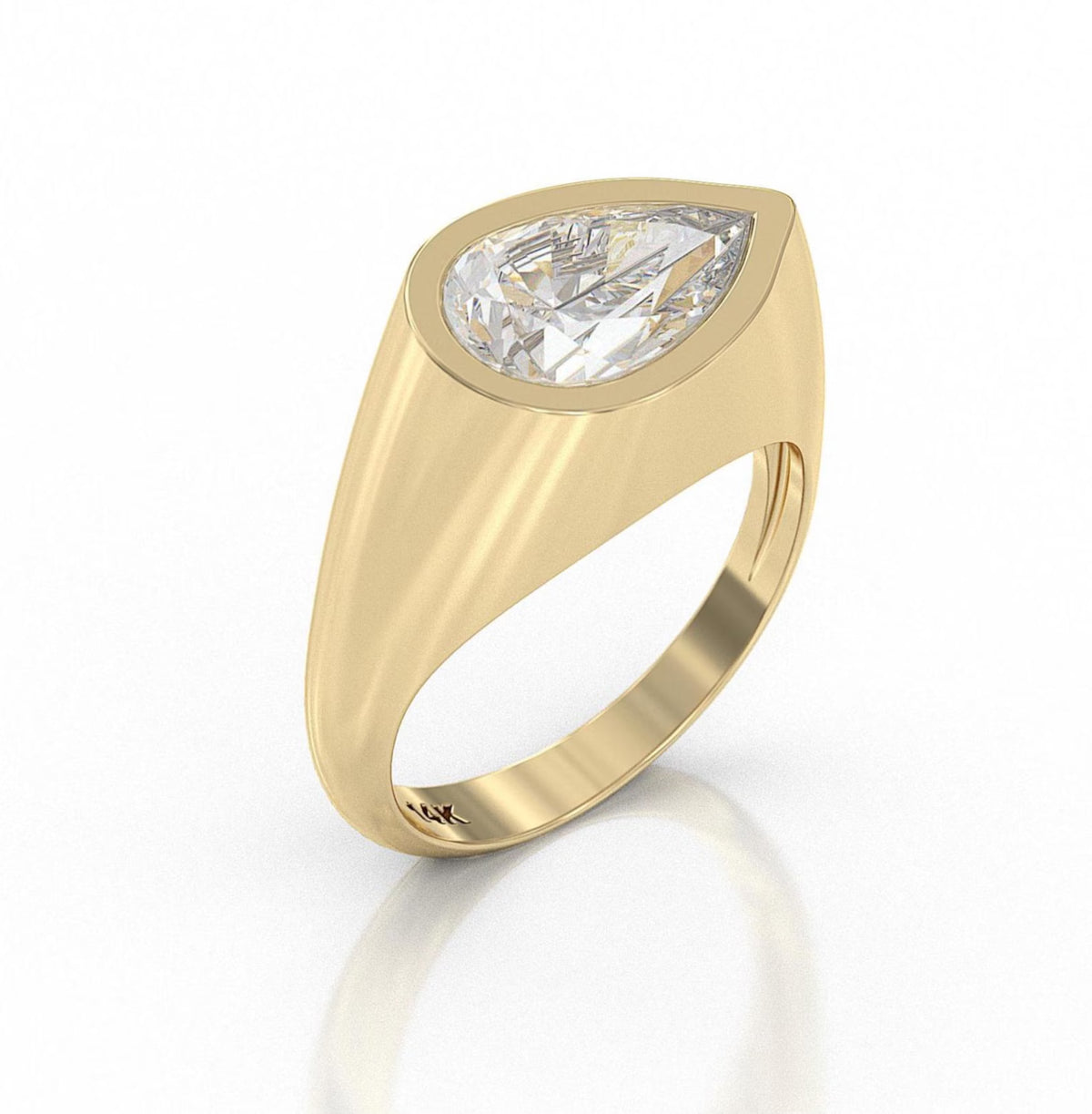 A yellow gold signet-style ring featuring a large pear-cut clear gemstone in a bezel setting, shown on a clean white background with a soft reflection below.