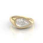Side angle of a bold 3 carat pear cut lab diamond signet ring showcasing the wide yellow gold band.