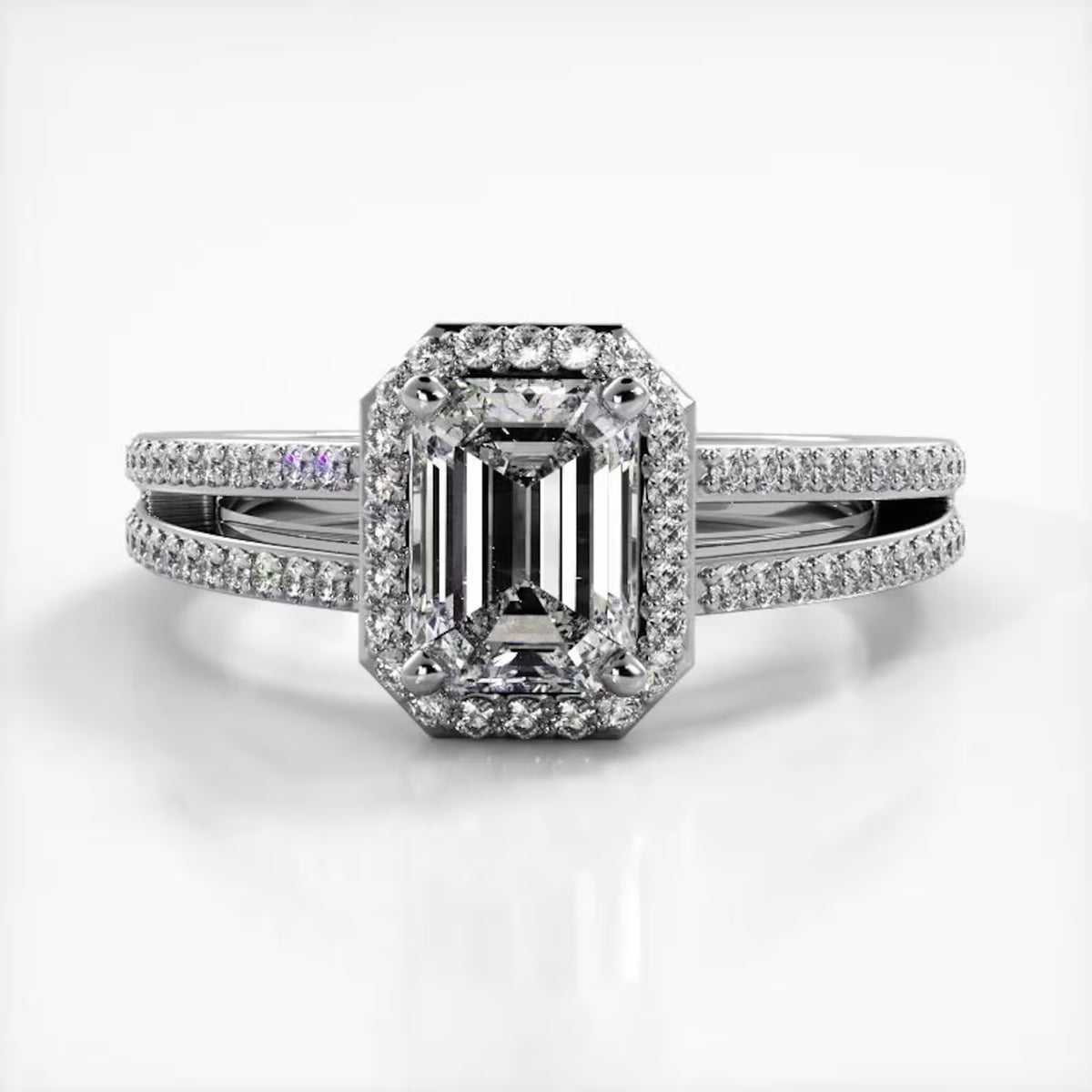 Front view of 2 CT emerald cut lab grown diamond ring in white gold featuring a micro-pave halo and split shank band.