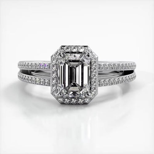 Front view of 2 CT emerald cut lab grown diamond ring in white gold featuring a micro-pave halo and split shank band.
