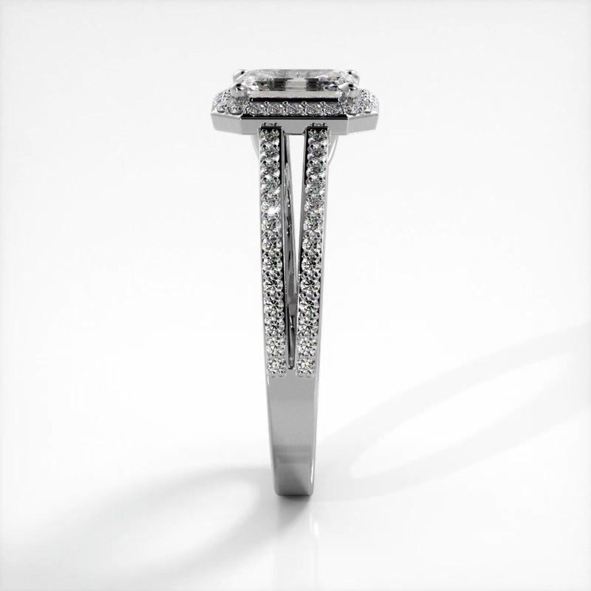 Side profile view of white gold 2 carat emerald cut lab grown diamond engagement ring showing pave split shank detail.