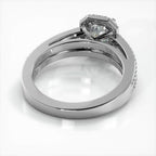 Angled bottom view showing the polished inner band and under-gallery basket of a white gold emerald cut lab diamond ring.