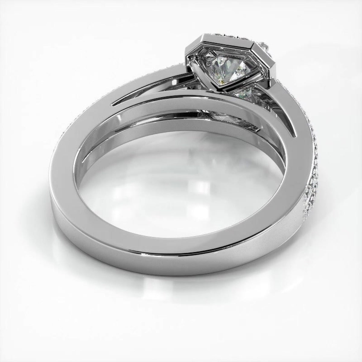 Angled bottom view showing the polished inner band and under-gallery basket of a white gold emerald cut lab diamond ring.