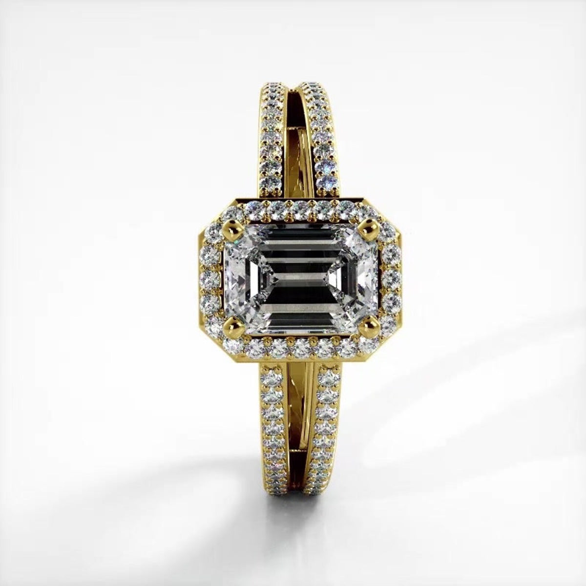 Direct top-down view of 2 CT emerald cut lab grown diamond ring with micro-pave halo set in 14K yellow gold.