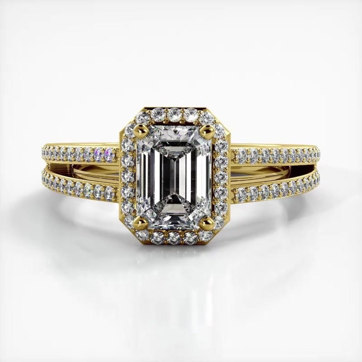 Front top-down perspective of 2 carat emerald cut lab diamond engagement ring in yellow gold with split shank.