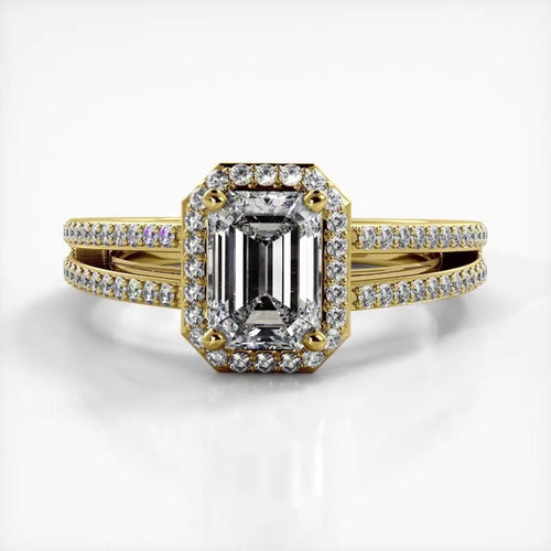 Front top-down perspective of 2 carat emerald cut lab diamond engagement ring in yellow gold with split shank.