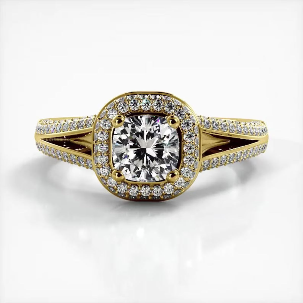 Front view of 2 CT cushion cut lab grown diamond ring with micro-pave halo and split shank band in yellow gold.
