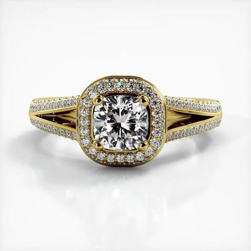 Front view of 2 CT cushion cut lab grown diamond ring with micro-pave halo and split shank band in yellow gold.