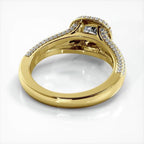 Angled bottom view showing the polished inner band and cathedral basket of a yellow gold cushion cut lab diamond ring.