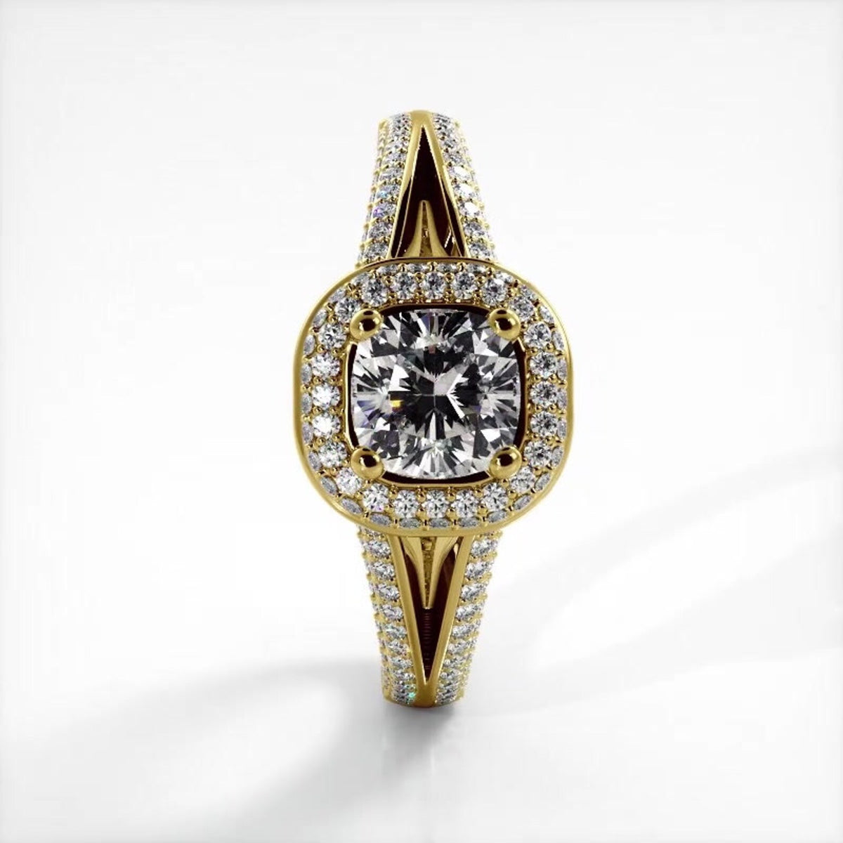 Direct top-down view of 2 CT cushion cut lab grown diamond ring with micro-pave halo set in yellow gold.